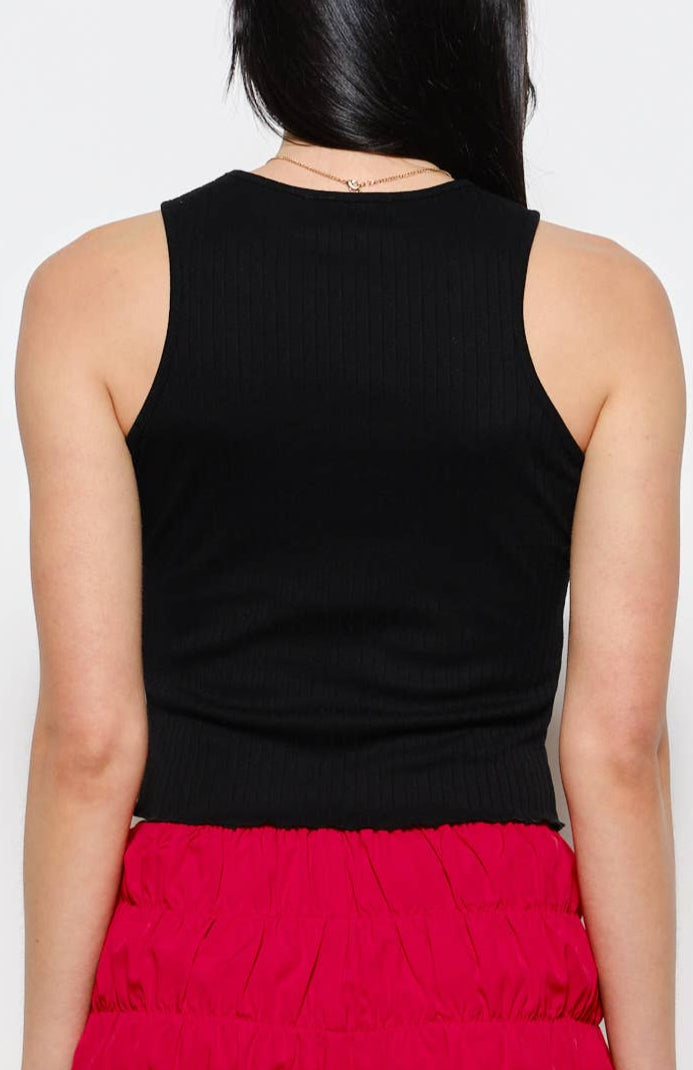 Person wearing a black sleeveless top and red shorts on a white background