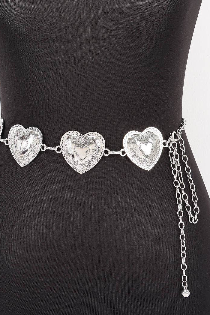 A silver heart-patterned waist chain displayed on a black mannequin torso against a white background.
