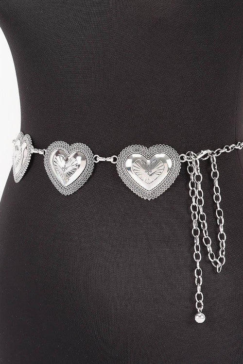 Silver heart-shaped belt with chain on a black dress form against a white background