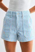 Blue and white striped shorts worn by a person on a plain background