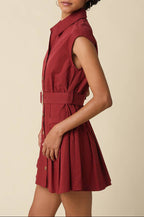 Woman wearing a red dress against a beige background