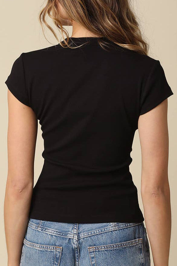 Person wearing a black t-shirt and blue jeans on a beige background