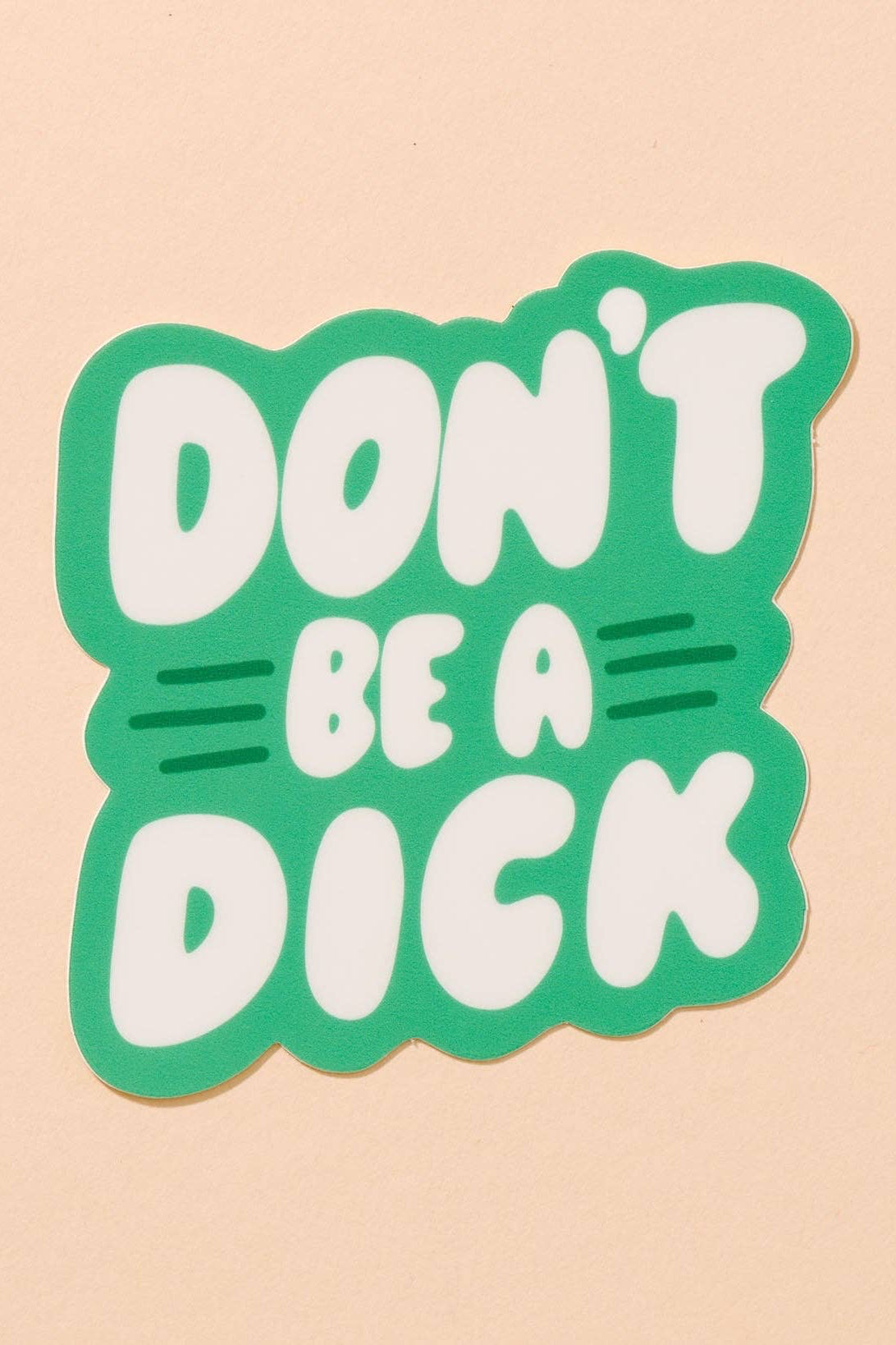 Sticker with 'Don't Be a Dick' text on a beige background