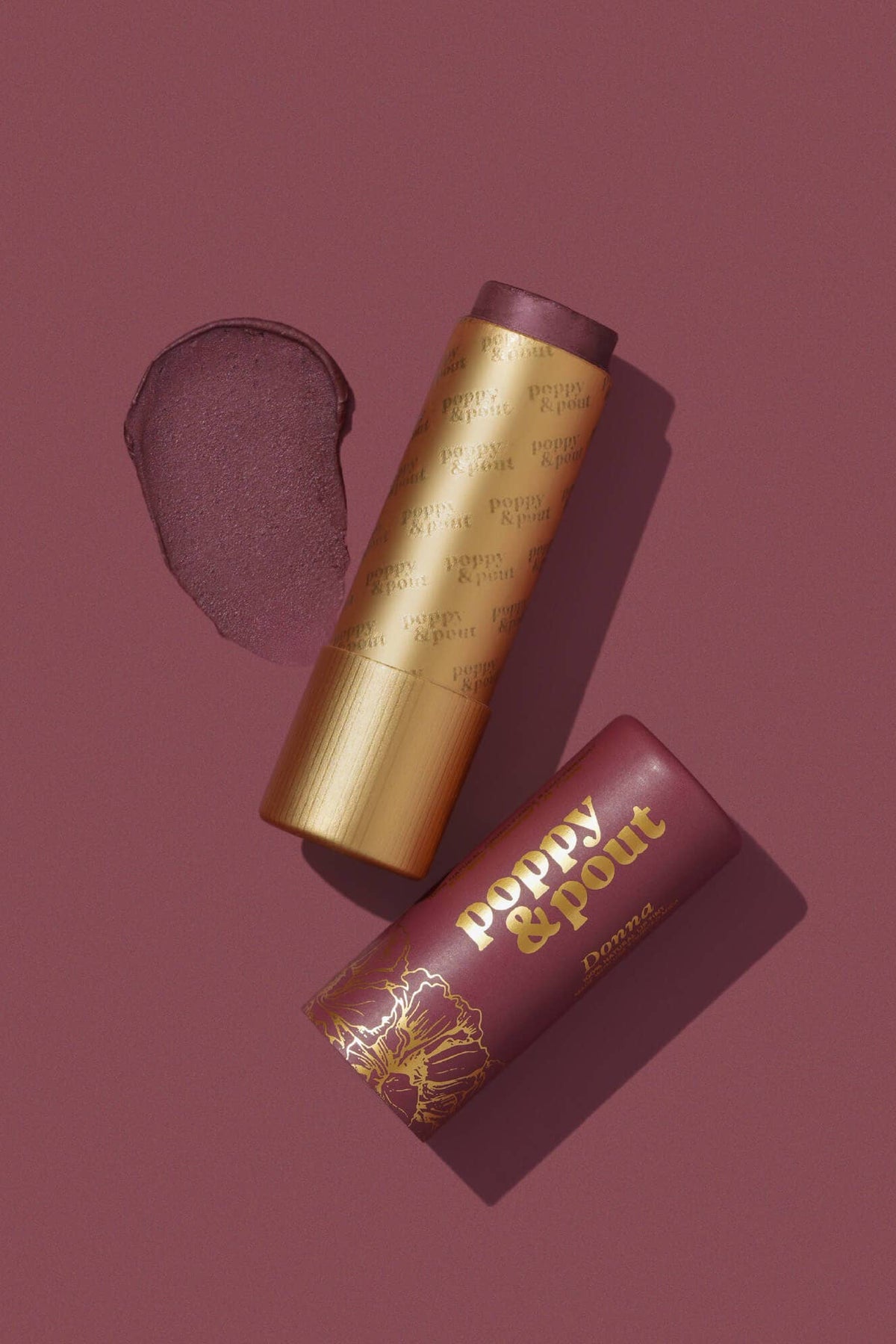 Two lip products with 'Poppy & Pout' branding on a maroon background