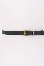 Black belt with a gold buckle on a white background