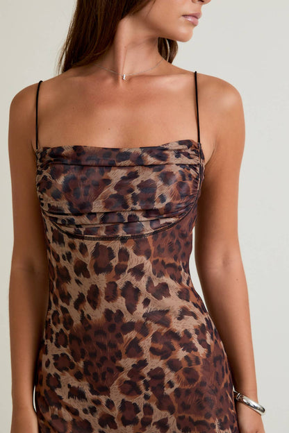 Leopard print dress worn by a model on a plain background