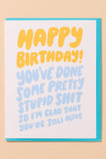 Birthday card with humorous text on a beige background