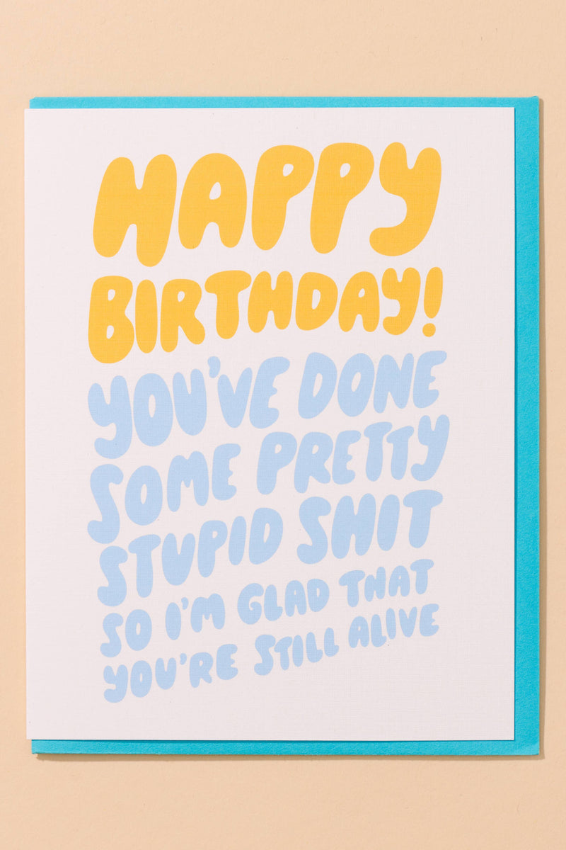Birthday card with humorous text on a beige background
