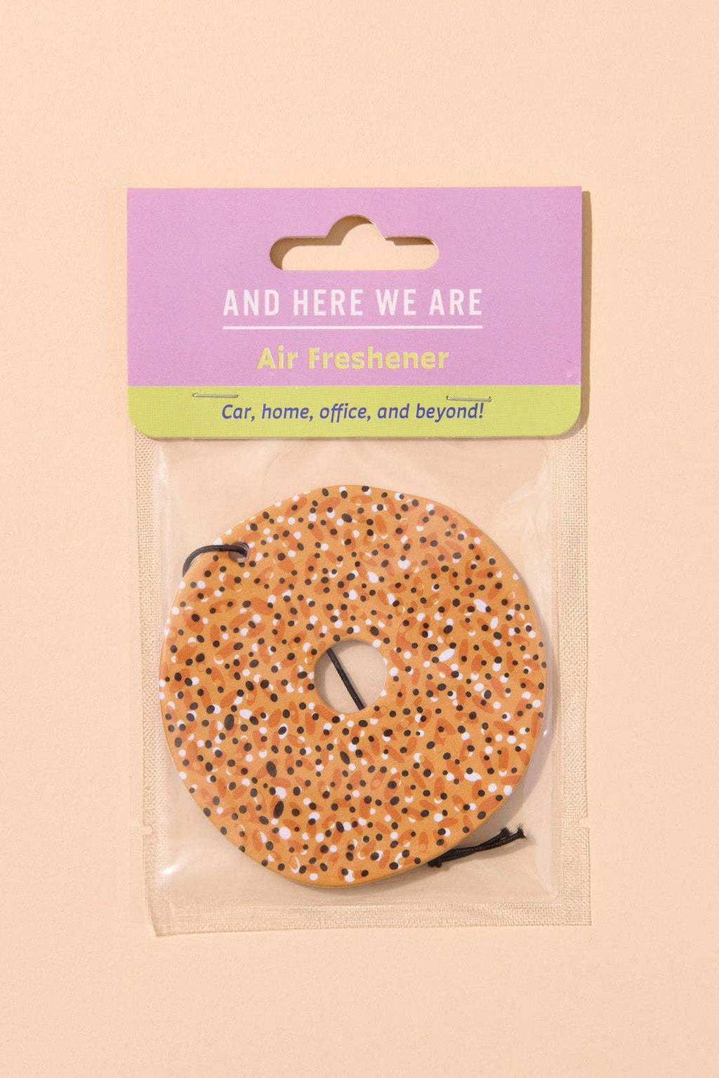 Air freshener with packaging labeled 'And Here We Are' on a beige background