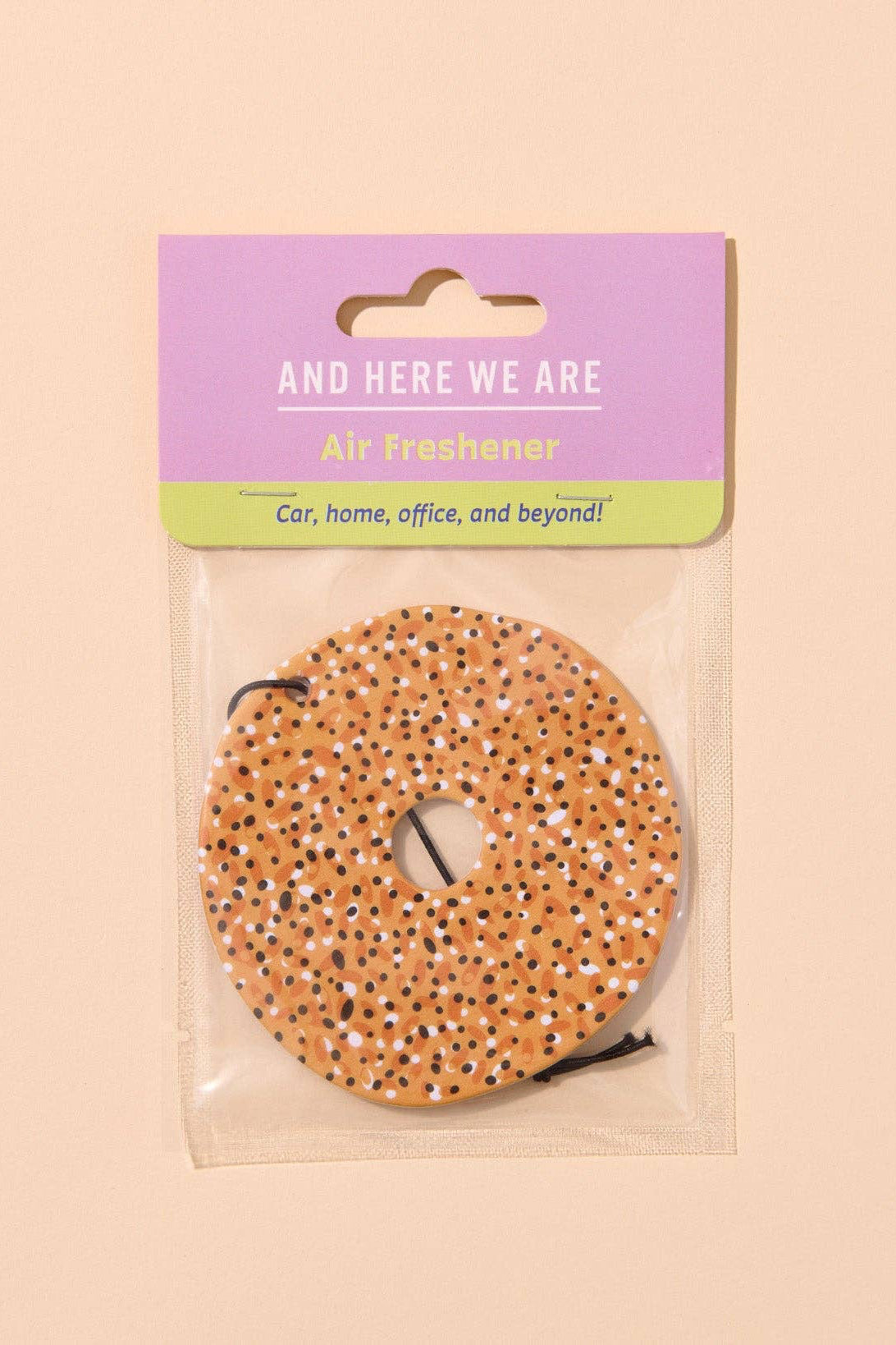 Air freshener with packaging labeled 'And Here We Are' on a beige background