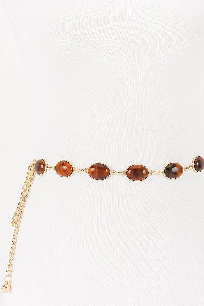 Gold belt with brown beads on a white background