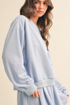Woman wearing a light blue dress against a beige background