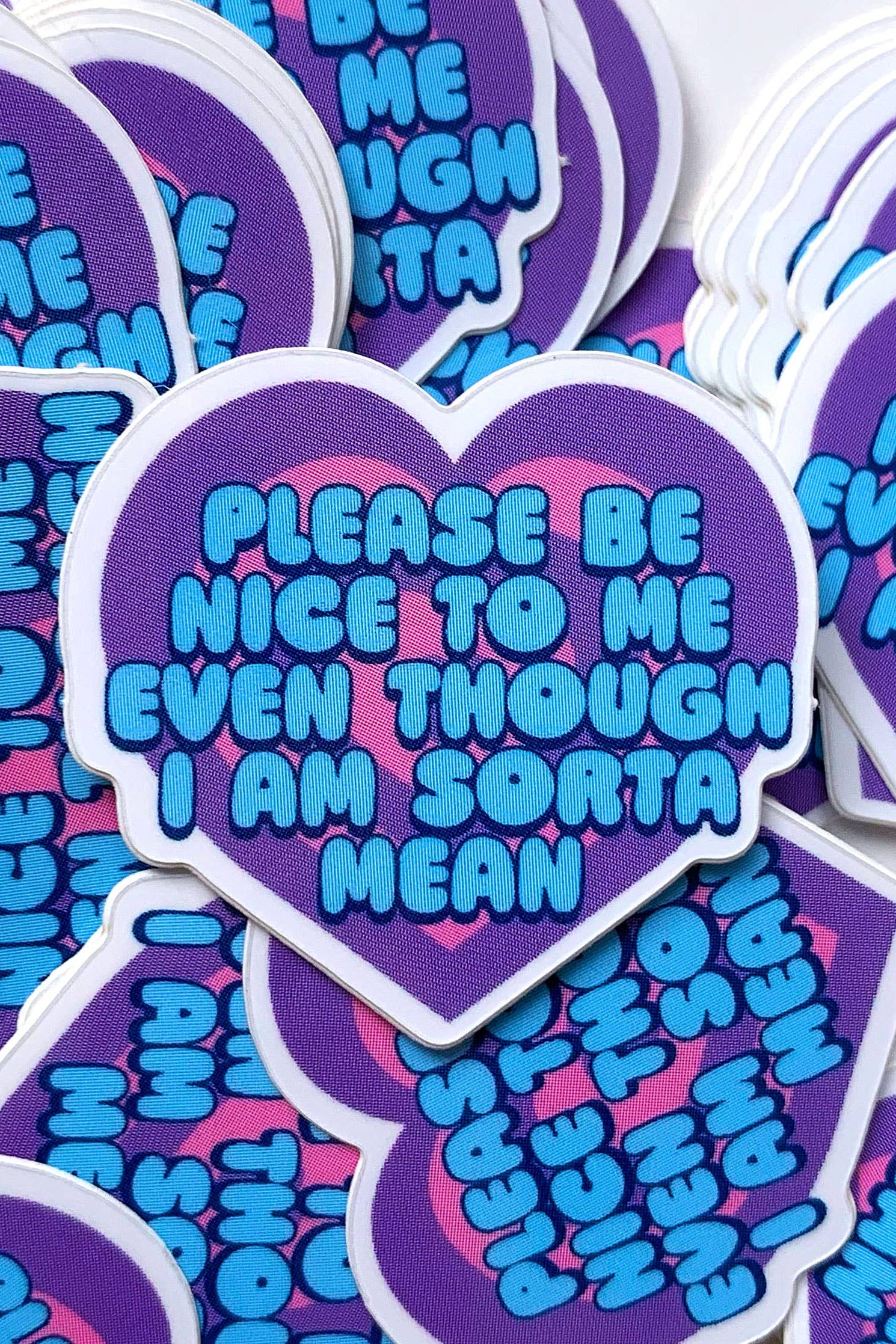 Heart-shaped stickers with text 'PLEASE BE NICE TO ME EVEN THOUGH I AM SORTA MEAN' on a white background