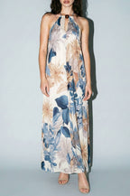 Woman wearing a floral dress against a plain background