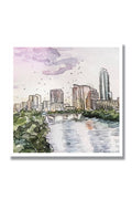 Watercolor painting of a city skyline with buildings and a river.