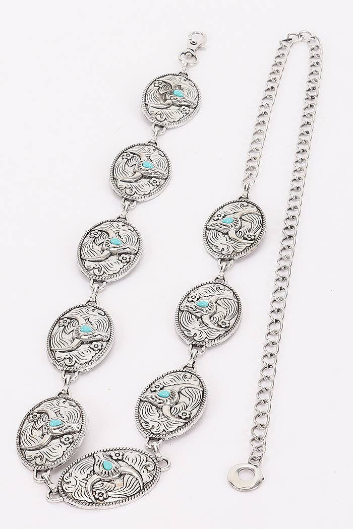 A silver-toned metal chain bracelet featuring seven oval links with detailed floral engraving and small turquoise blue inlays, displayed on a clean white background.