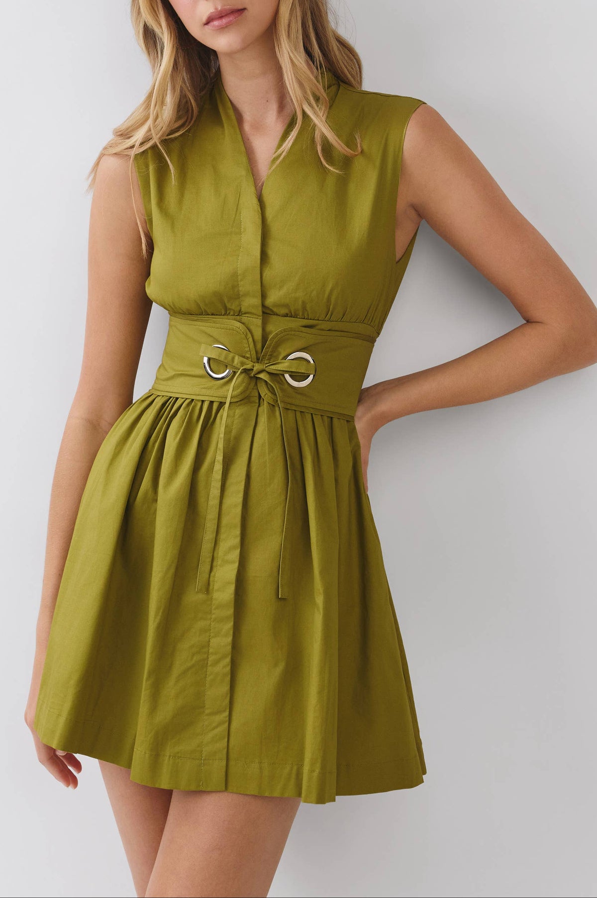 Woman wearing a green dress against a white background