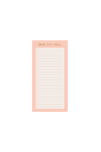 Extra small notepads with a pink and blue cover, alongside a pen, paper clips, washi tape, and a glue stick, all arranged on a beige background.