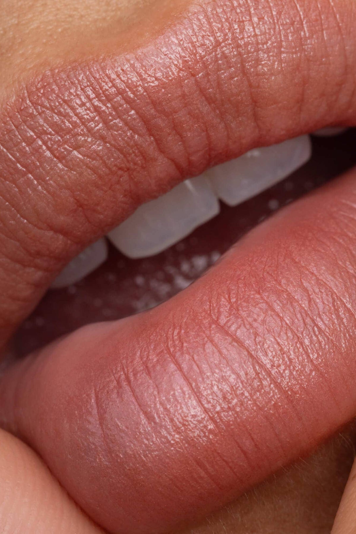 Close-up of a person's lips with a focus on texture and color.