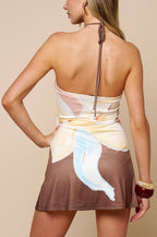 Woman wearing a colorful dress with a neutral background