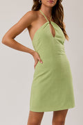 Woman wearing a green dress against a white background