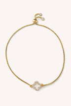 Gold necklace with a decorative clasp on a white background