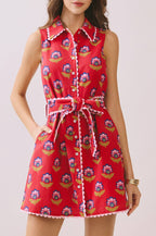 Woman wearing a red floral dress on a light background