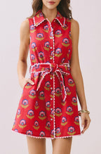 Woman wearing a red patterned dress on a white background