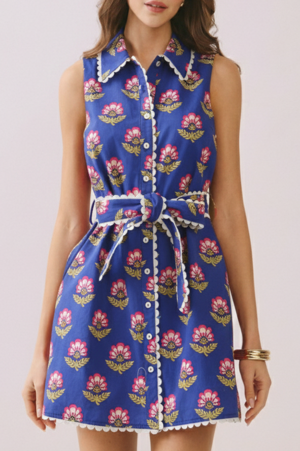 Woman wearing a blue floral dress on a light pink background