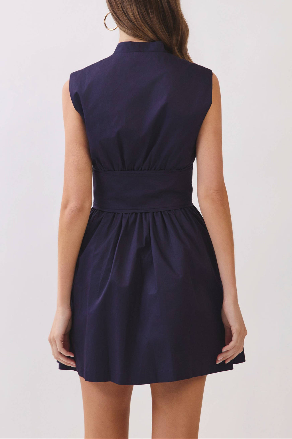 Navy blue dress worn by a person on a white background