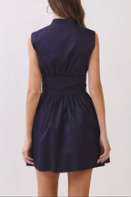 Navy blue dress worn by a person on a white background