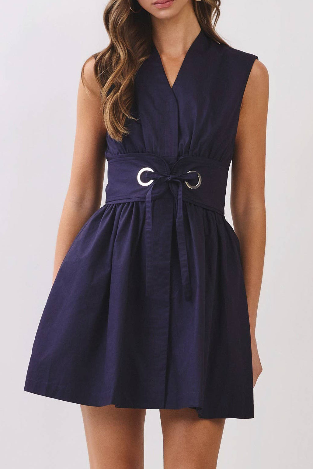 Woman wearing a navy blue dress on a white background