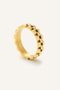 Gold ring with a textured design on a white background