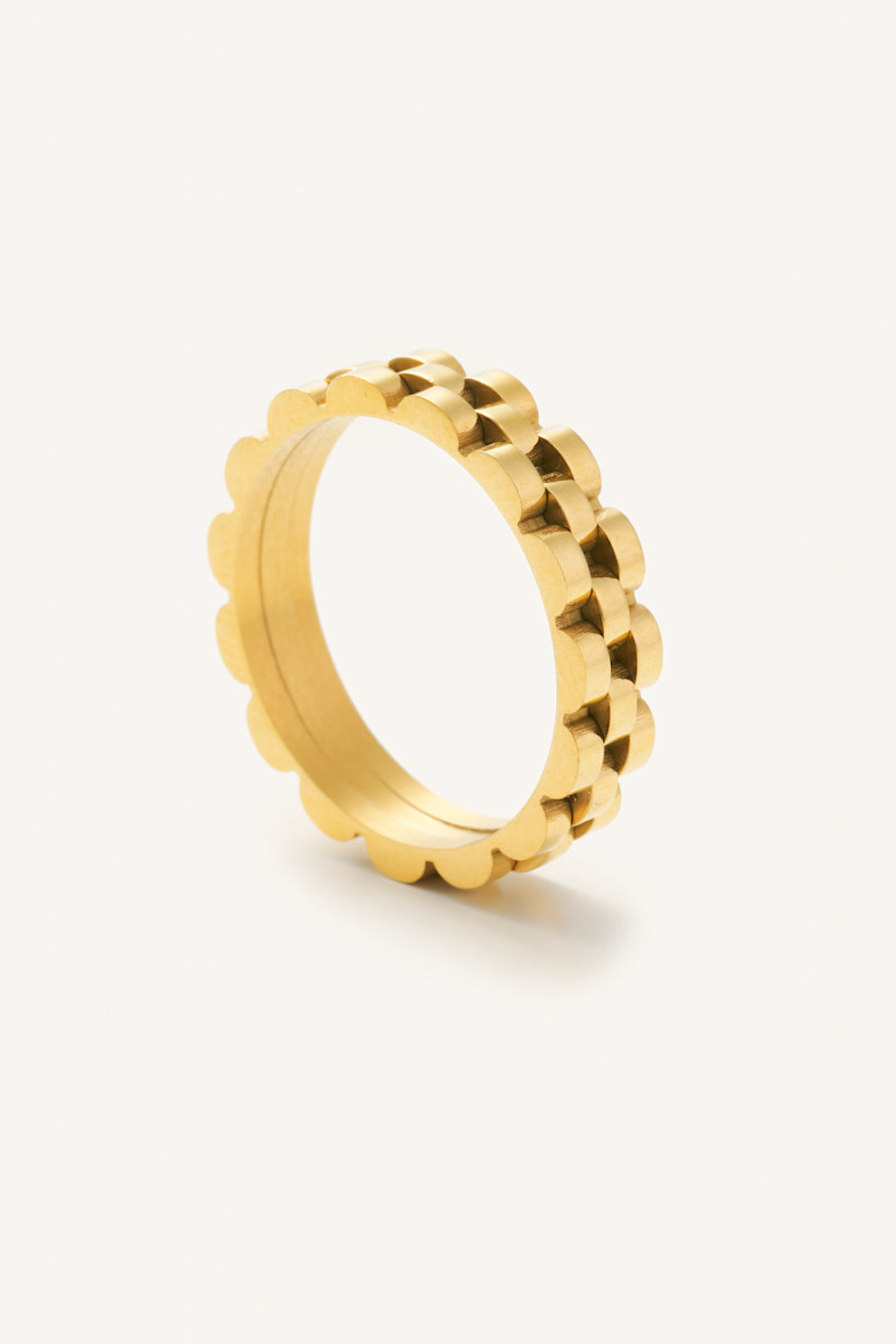 Gold ring with a textured design on a white background
