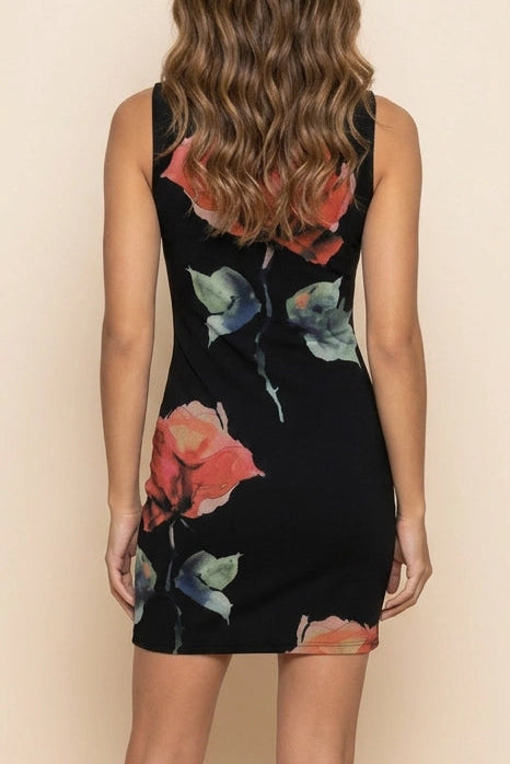 Woman wearing a black floral dress against a beige background