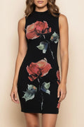 Woman wearing a black dress with floral patterns on a beige background