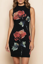 Woman wearing a black dress with floral patterns on a beige background