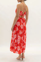 Woman wearing a red floral dress on a white background