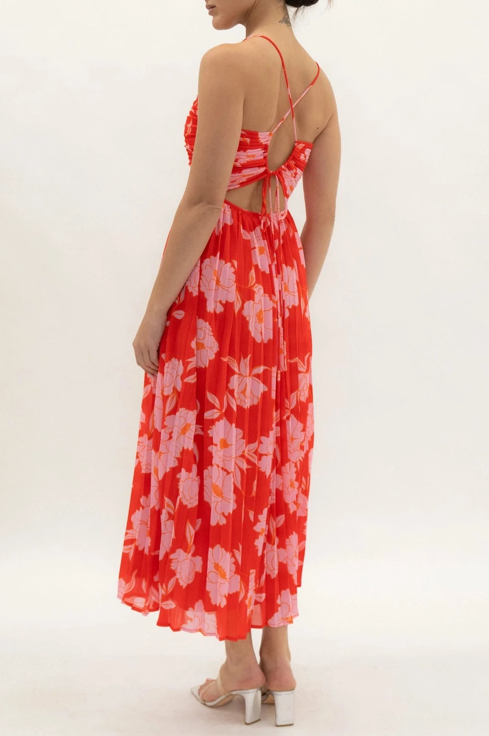 Woman wearing a red floral dress on a white background