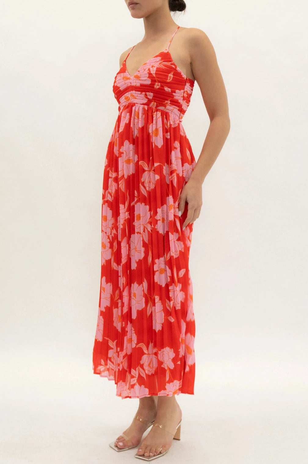 Woman wearing a red floral dress on a white background