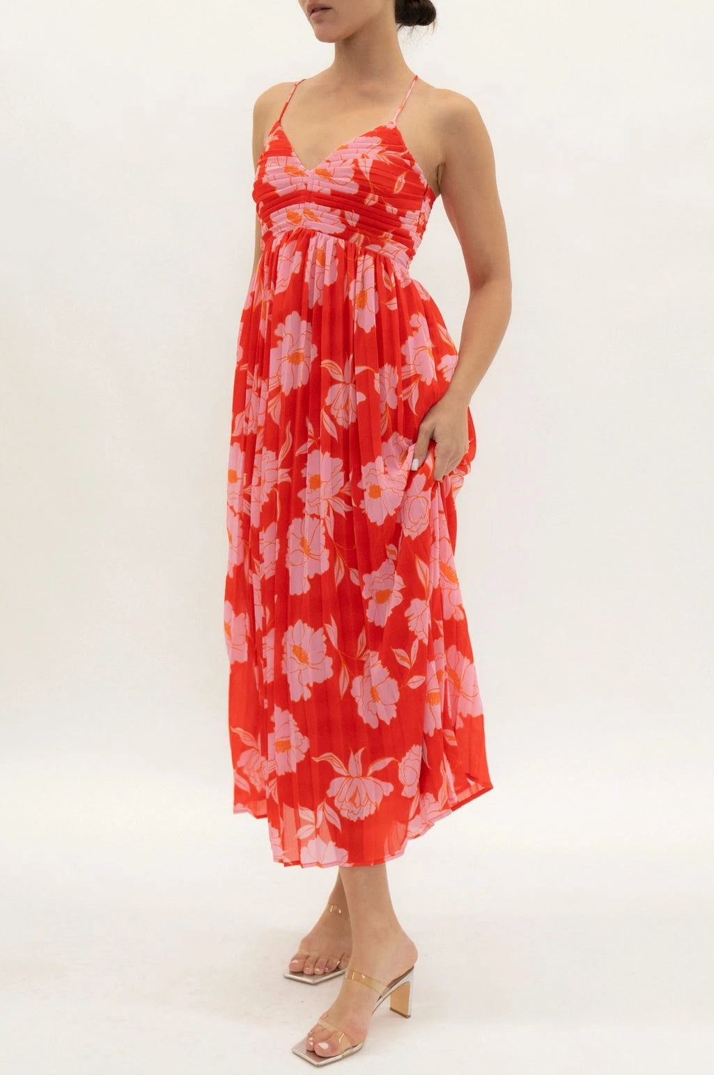 Woman wearing a red floral dress on a white background