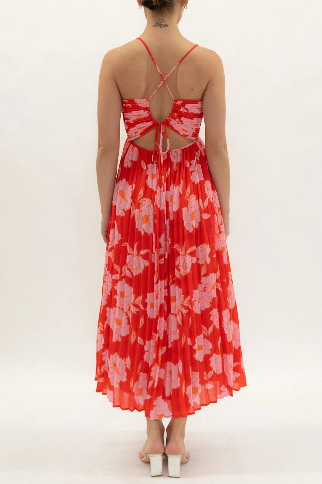 Woman wearing a red floral dress on a white background