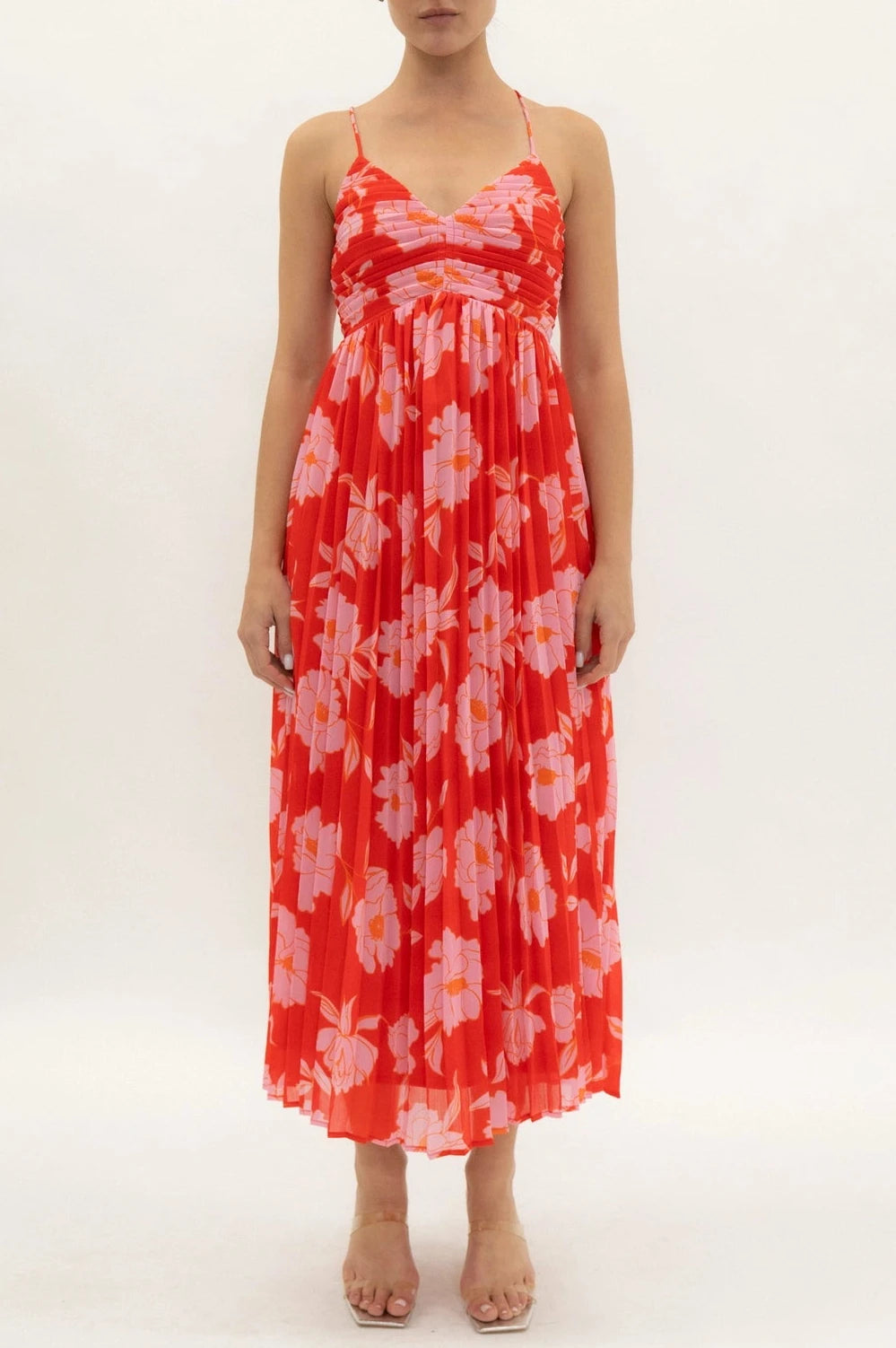 Woman wearing a red floral dress on a white background