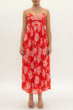Woman wearing a red floral dress on a white background