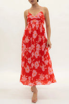 Woman wearing a red floral dress on a white background