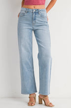 Light blue jeans worn by a person on a white background