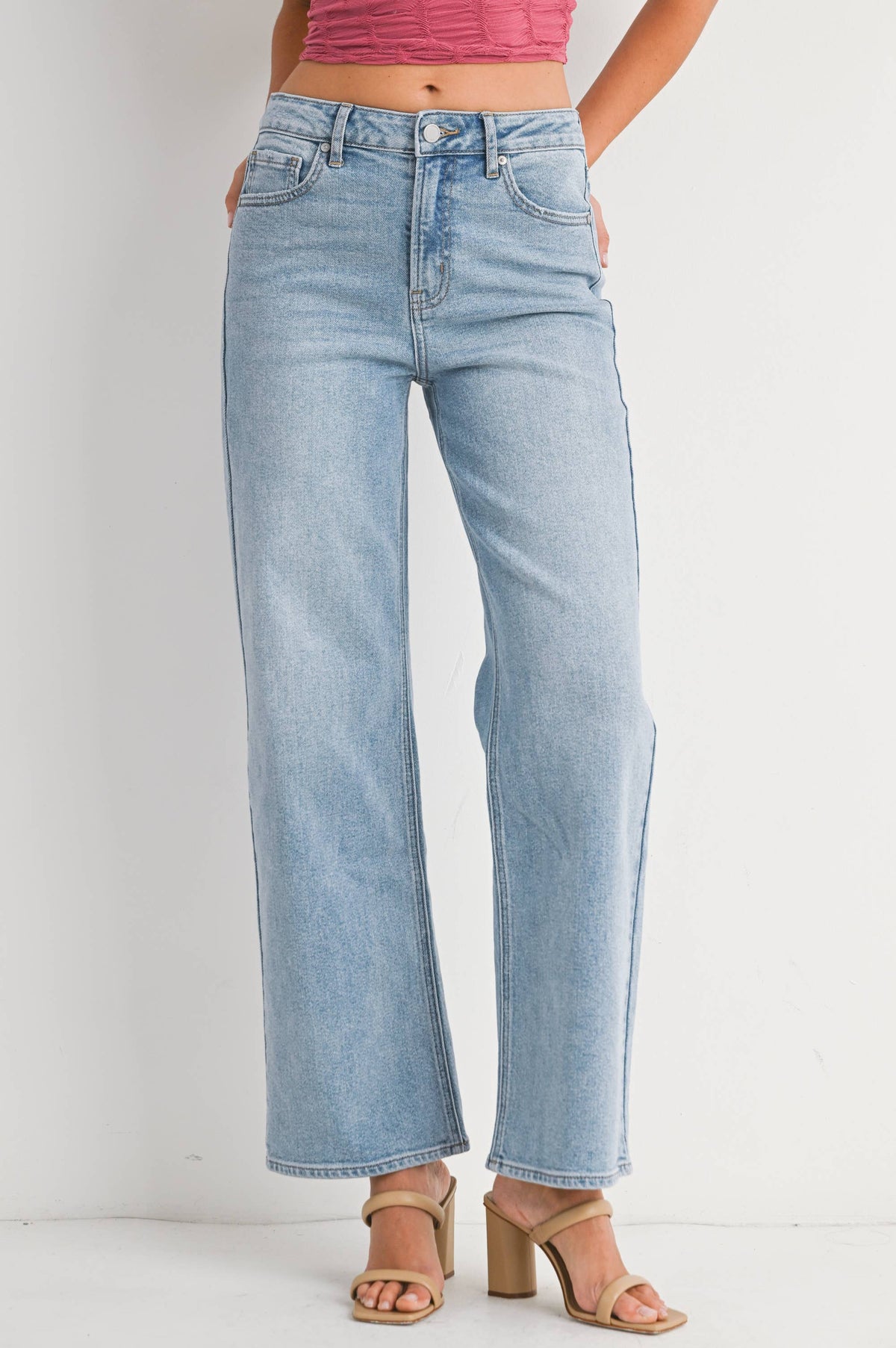 Light blue jeans worn by a person on a white background