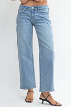 Light blue jeans worn by a person on a white background