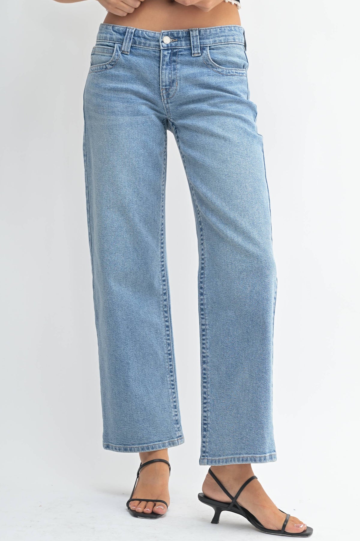 Light blue jeans worn by a person on a white background