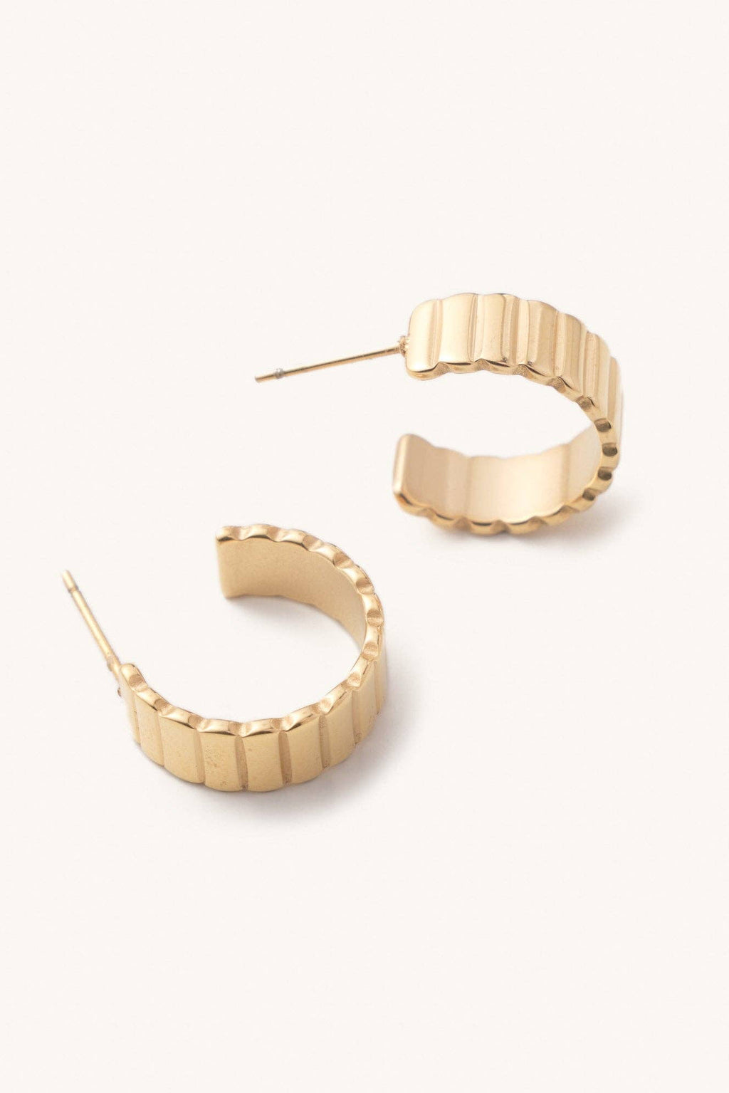 Gold hoop earrings on a white background